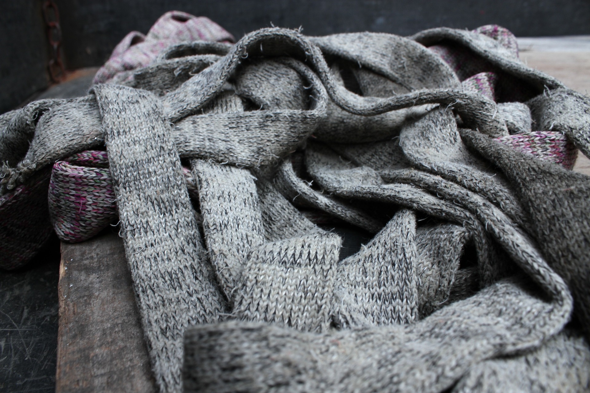 Student Disappears Under Pile of Discarded Scarves and Hats in Overly Warm Classroom